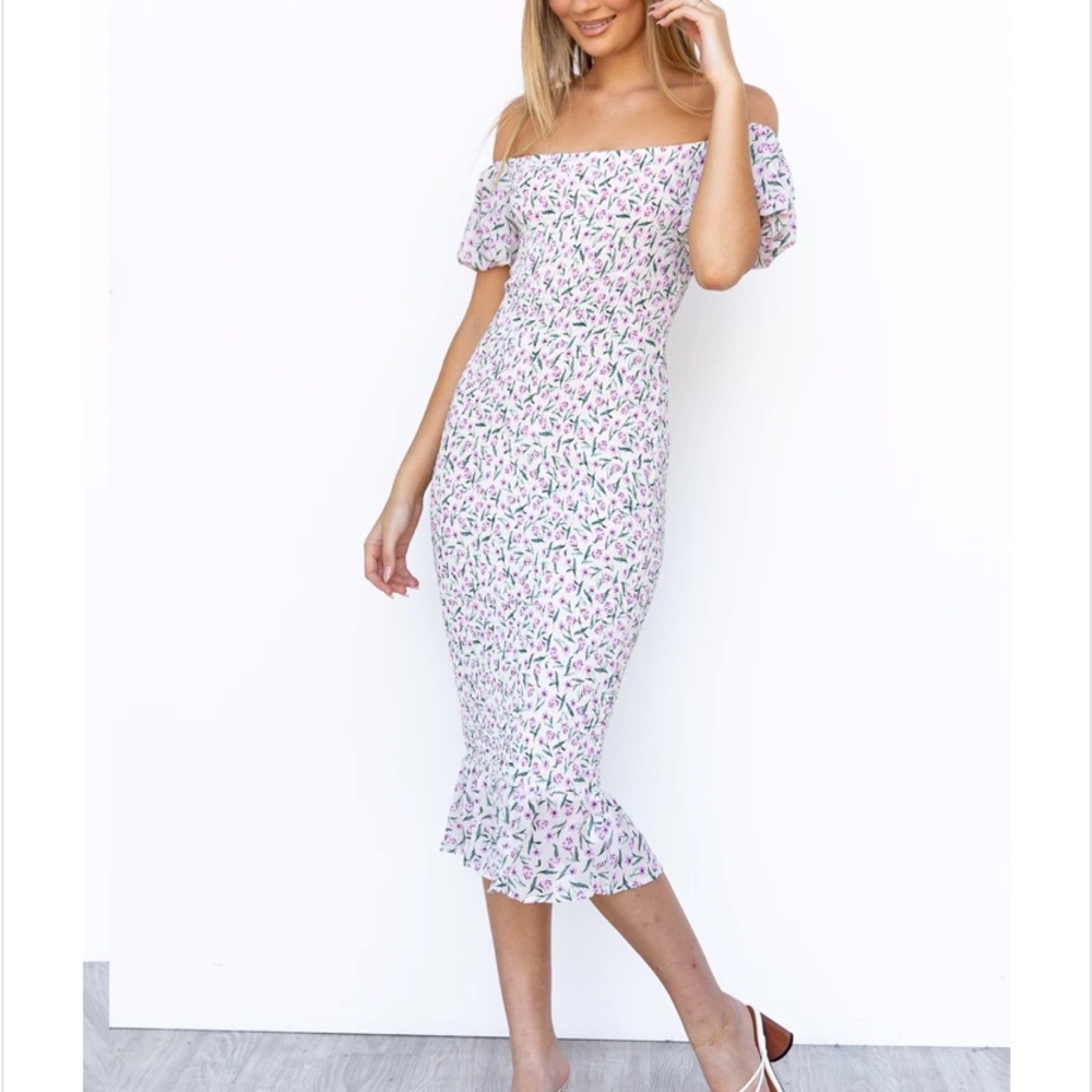 Beautiful floral smocked dress. New with tags. Not maternity but bump friendly.